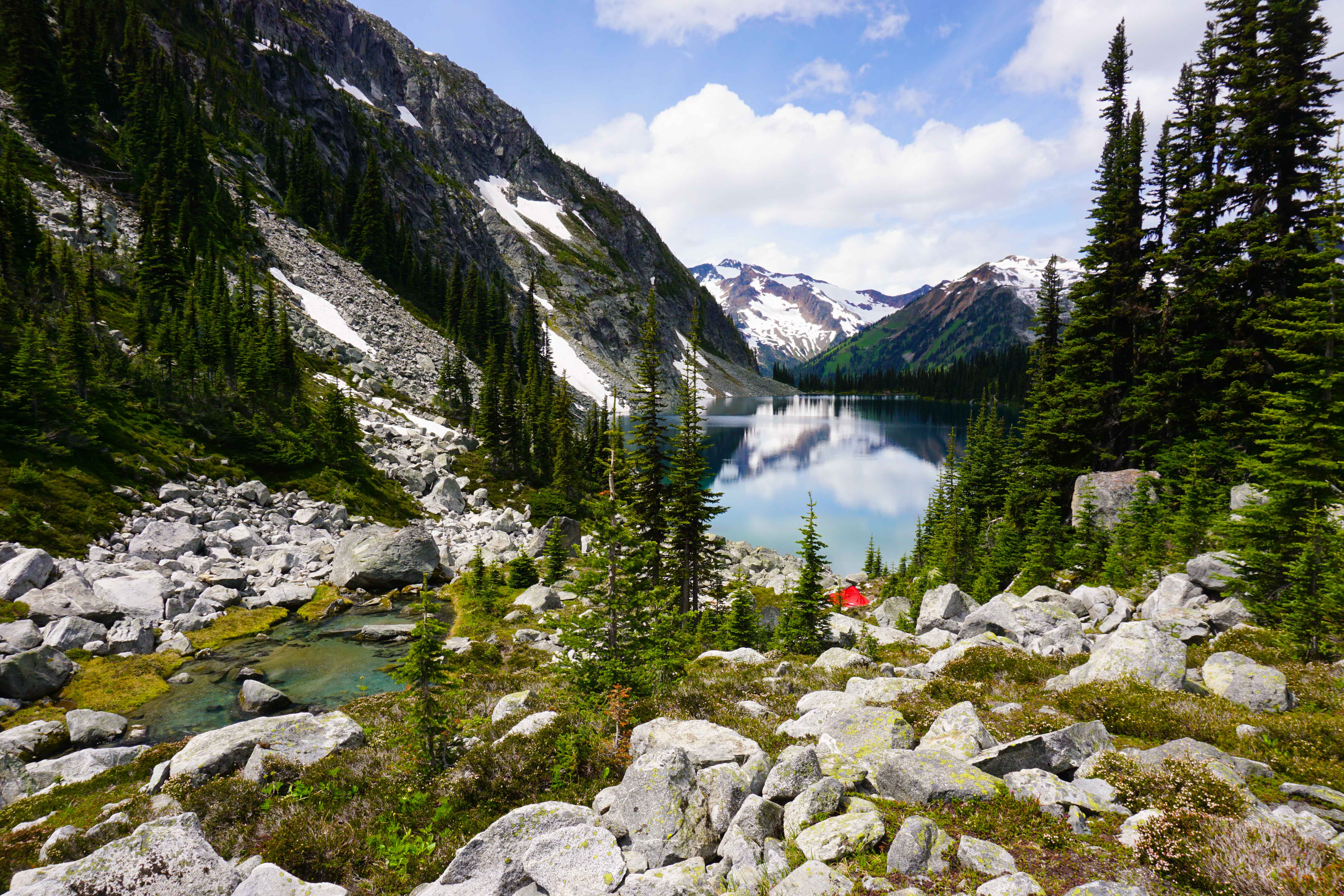 Tent pitched in front of lake