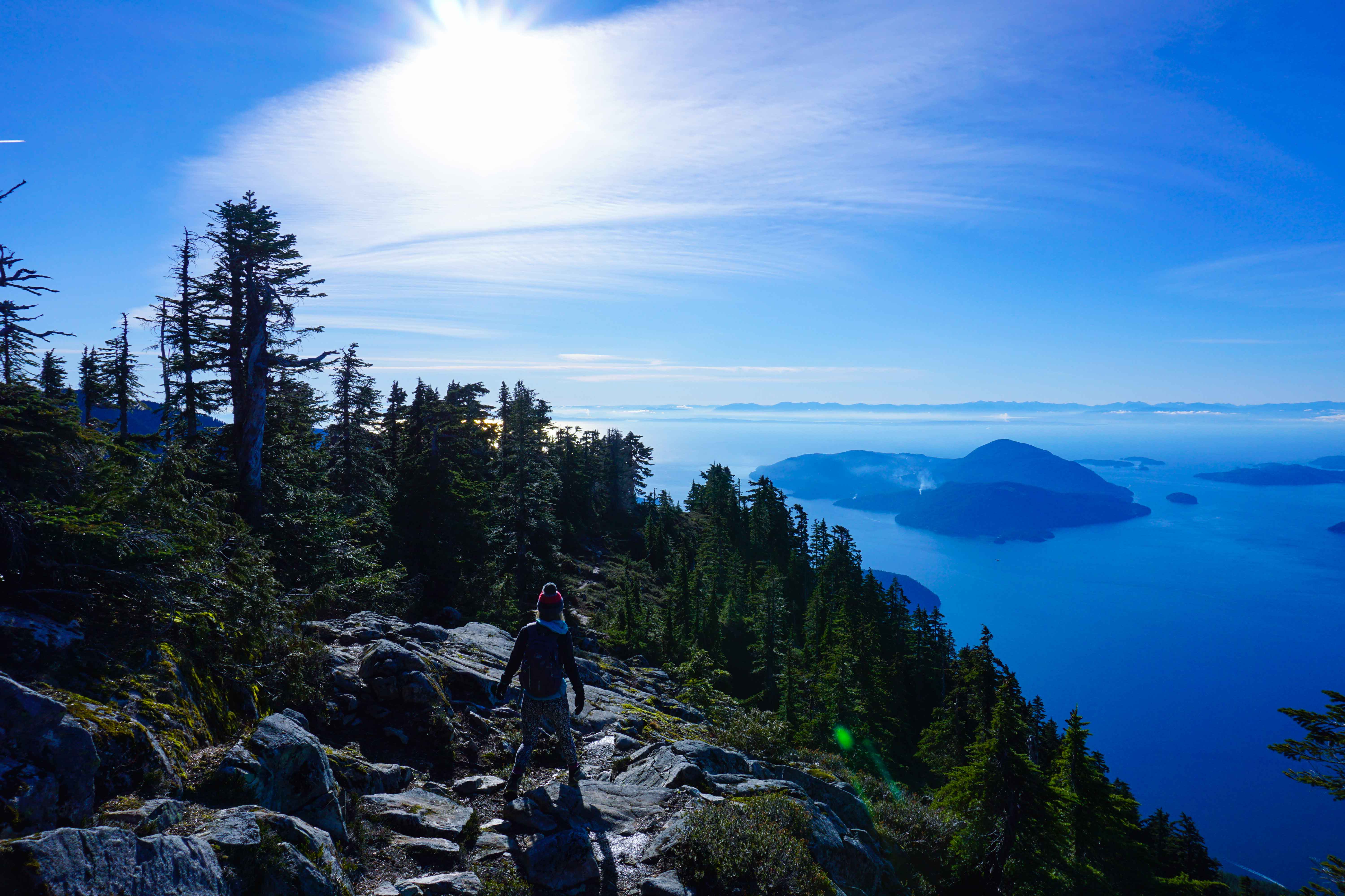 Woman walks along mountain top