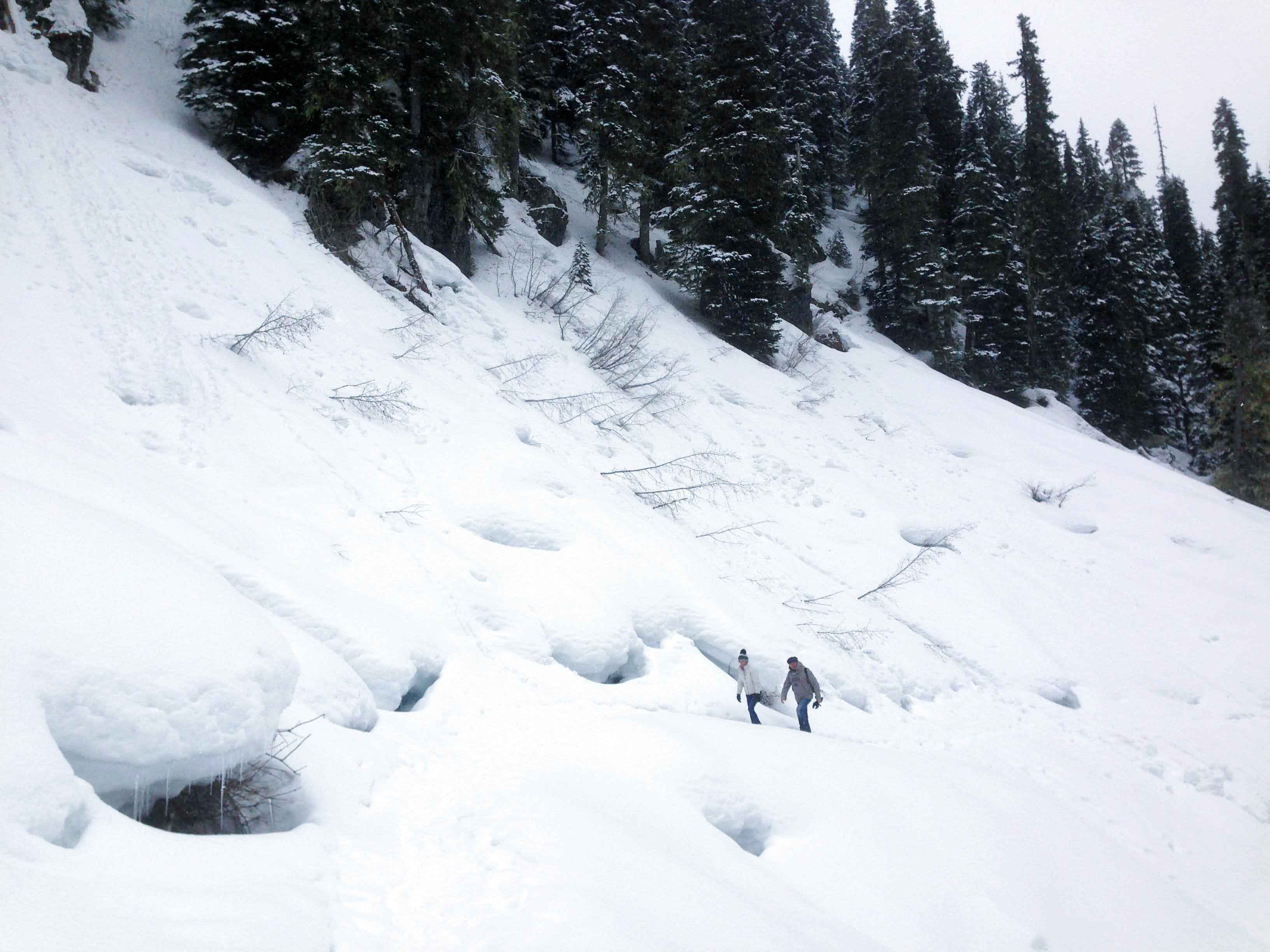Man and woman hike in the snow