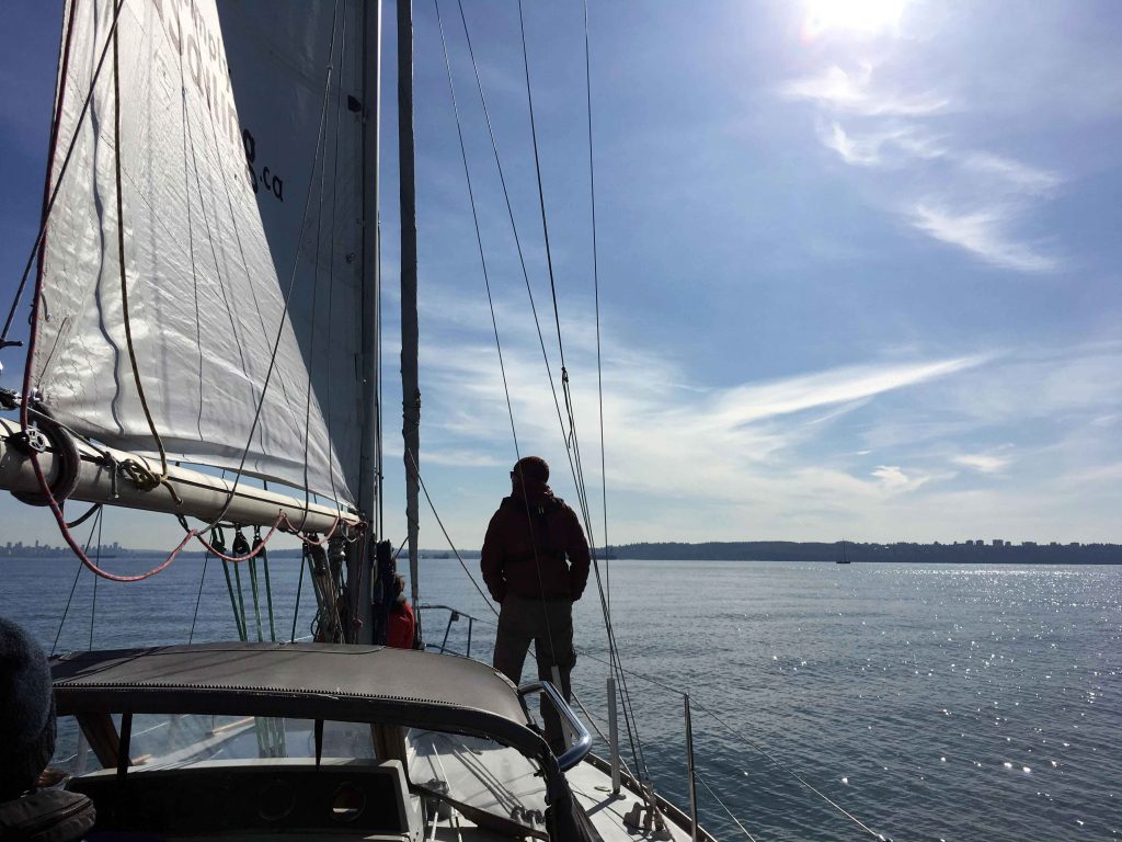 Sailboat on the sea with man on the bow