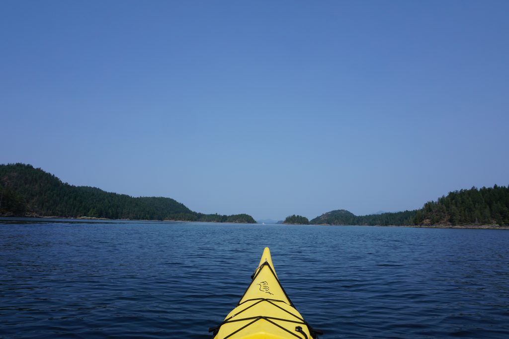 Nose of yellow kayak surrounded by sea