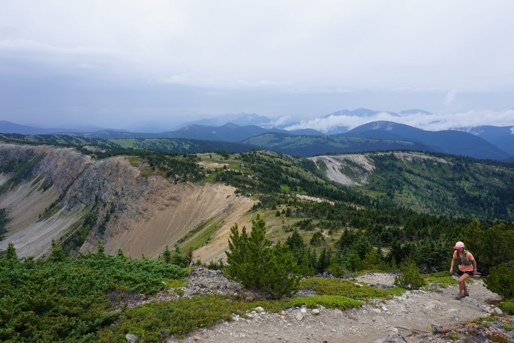 Woman walks up mountain ridge