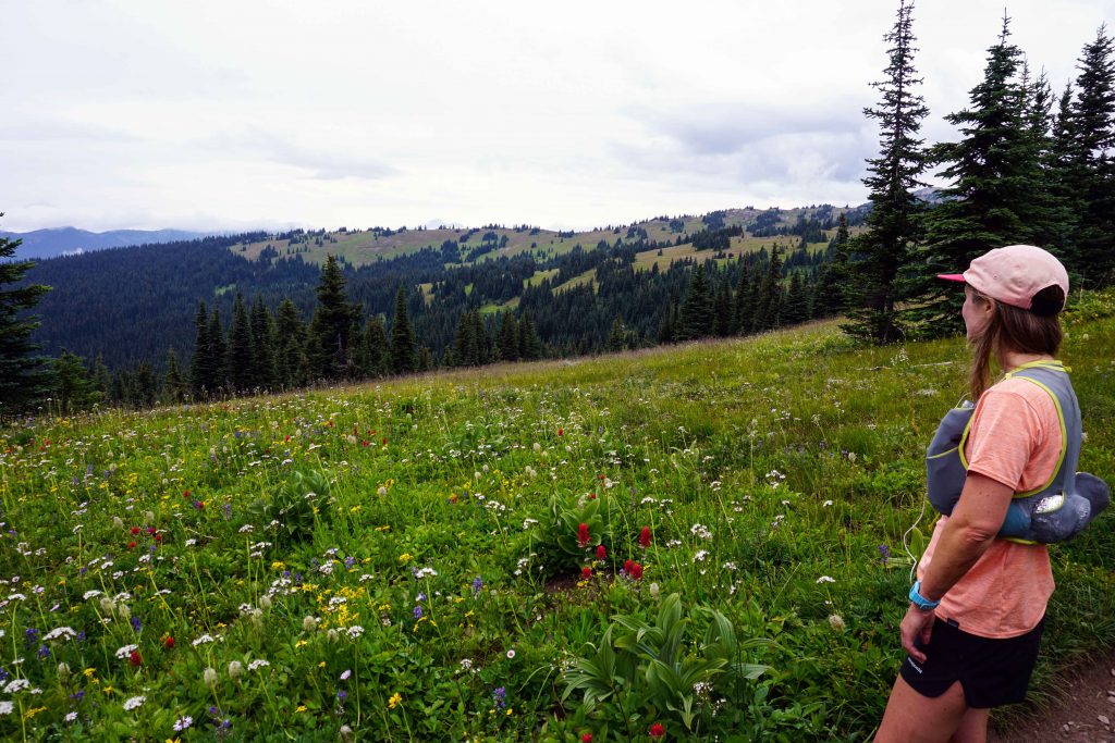 Woman stands in meadow