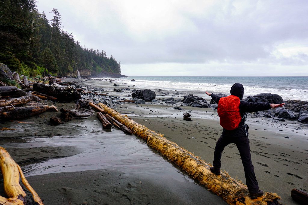 Woman does yoga pose on empty beach