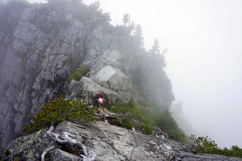 Woman scrambles up mountainside