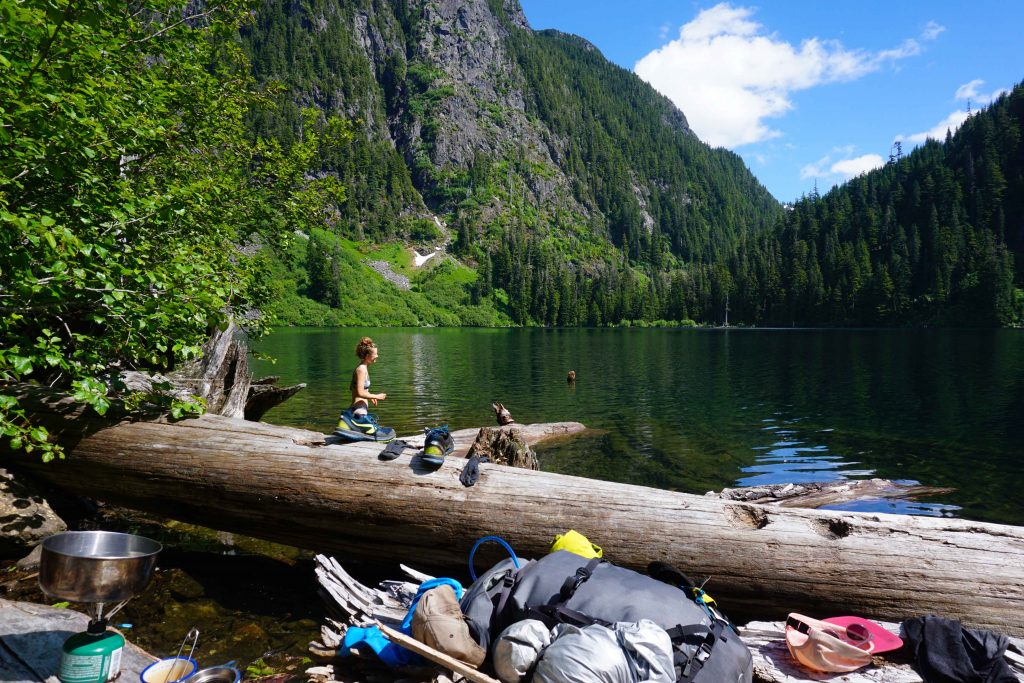 Woman swims in alpine lake