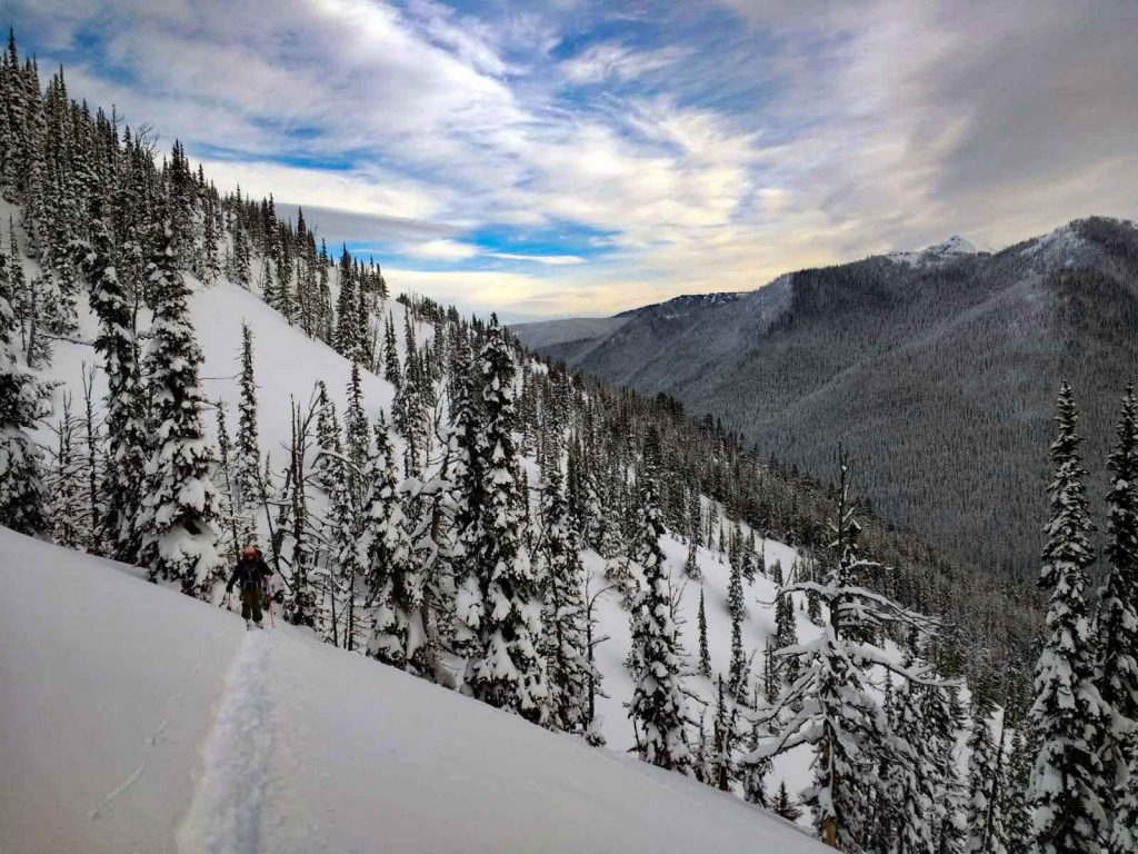 Person traverses snowy slope
