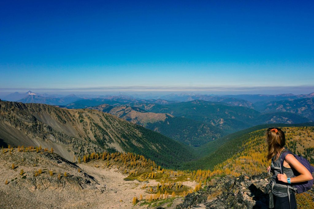 Woman looks across mountain range