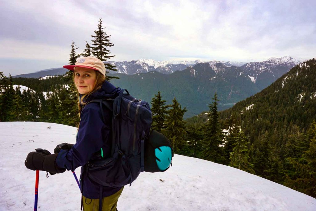 Woman on skis in snowy mountains