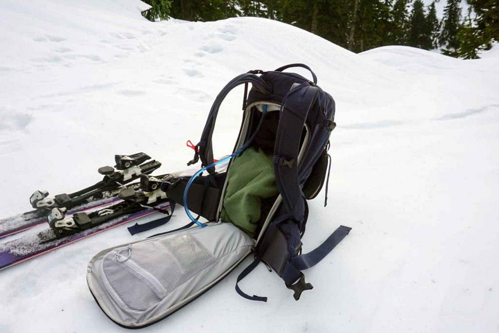 Open backpack on snowy ground