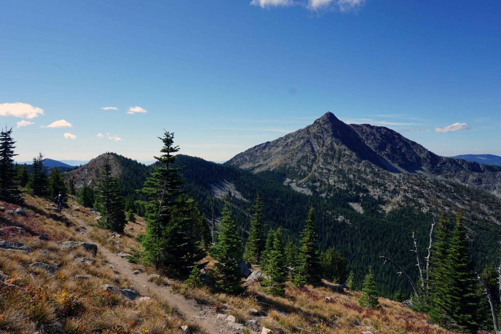 Person mountain biking along mountain ridge